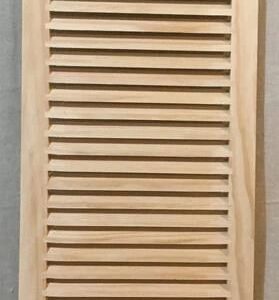 A wooden shutter with no frame on top of it.