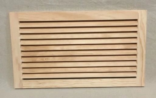 A wooden slat air vent on the wall.