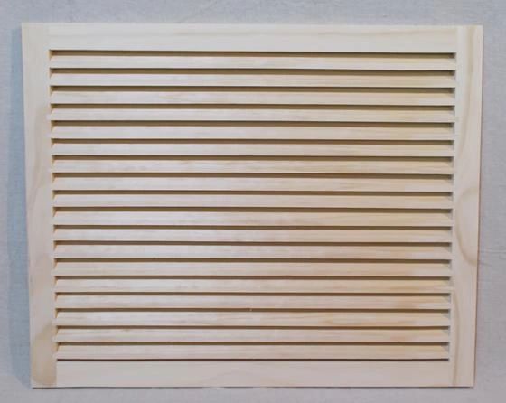 A white shutter with slats on it's sides.
