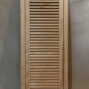 A wooden cabinet with a louvered door.