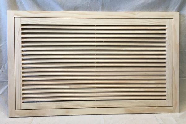 A wooden air vent with slats on it.