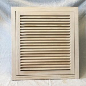 A wooden air vent on the side of a wall.
