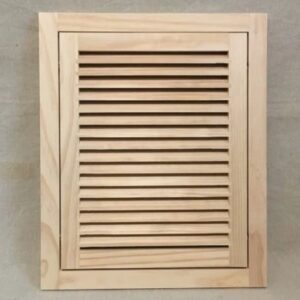 A wooden cabinet door with slats on the top.