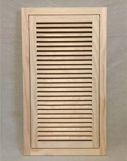 A wooden door with slats on the top and bottom.