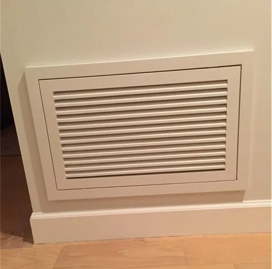 A white wall with a vent on the side of it