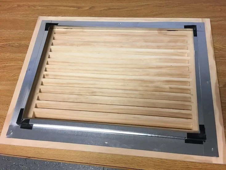 A wooden board with metal bars on top of it.