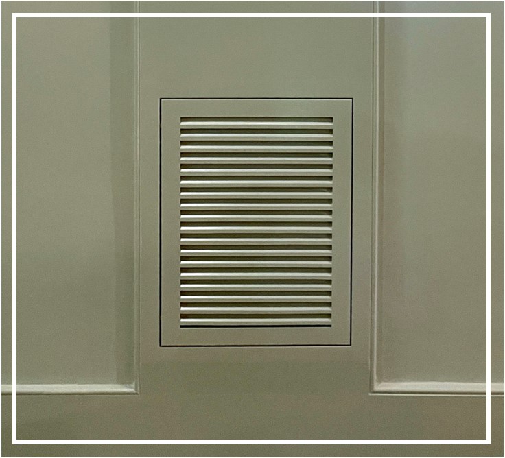 Wood Return Air Filter Grille seamlessly installed in media room